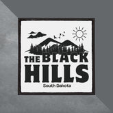 Patch with 'The Black Hills, South Dakota' text and mountain design on a gray background